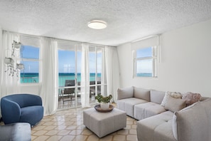 Bright and airy living room with a comfortable couch and large window—a great space to unwind!