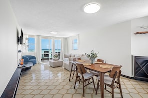 Modern dining space with a sleek table and open living area—perfect for meals and relaxation!