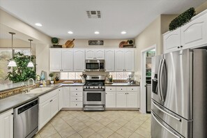  The home features a spacious kitchen and large dining table.