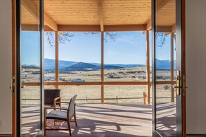 Large double doors opening up to your expansive covered porch with views of the entire valley.
