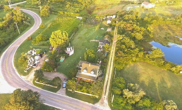 Aerial view of property- House in foreground is the 3 bedroom farmhouse. 