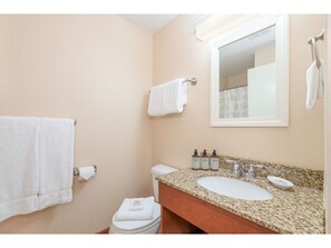 A well-appointed bathroom with warm lighting and modern touches adds to the comfort of your stay.