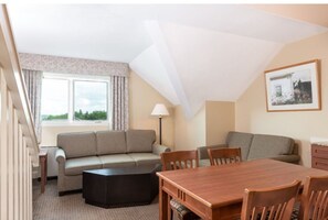 Relax and connect in the inviting living and dining area, designed to make you feel at home with its cozy furnishings and welcoming atmosphere.