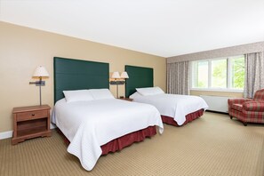 Spacious bedroom with a serene ambiance and natural light, offering a tranquil retreat for rest and relaxation.