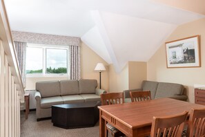 Relax and connect in the inviting living and dining area, designed to make you feel at home with its cozy furnishings and welcoming atmosphere.