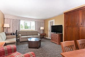 Unwind in the spacious living area, complete with comfortable seating and an inviting atmosphere for conversation and relaxation.