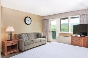 Comfortable living area with a plush sofa and ample natural light, providing a welcoming space to relax and unwind.