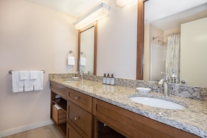 Spacious bathroom with double sinks and plenty of counter space, providing convenience and comfort for your stay.
