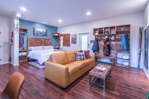 Comfy and spacious open-concept living area.  TV can be viewed from the cozy king-sized bed or from the queen-sized pullout couch.  Lots of room for your gear and clothing.