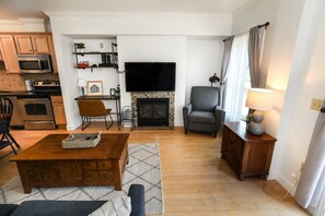 Bright and airy living space with a fireplace and an open layout, creating a warm and welcoming atmosphere.
