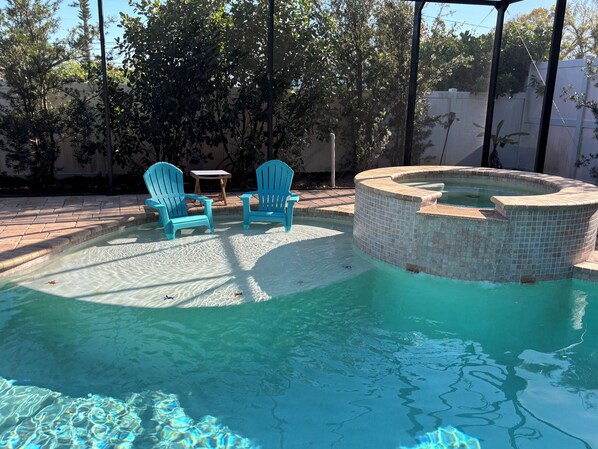 Heated Saltwater Pool and Hot Tub in screened area.
