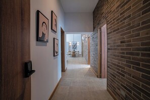 Hallway as seen from apartment entrance. Smart lock with code access.