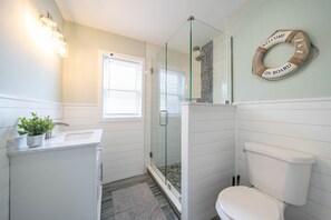 Bathroom Retreat: Enjoy rejuvenating showers in a stylish space adorned with modern fixtures!