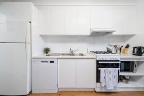 Whip up delicious meals in the well-equipped kitchen, featuring a gas stove, oven, and dishwasher for easy clean-up.