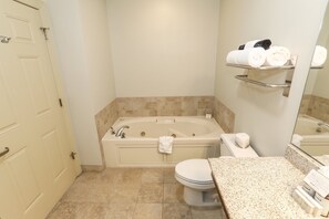 Spacious bathroom with a bathtub and modern fixtures for added comfort.