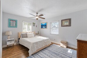 Guest bedroom with queen bed, trundle, and ceiling fan. Private bath with shower