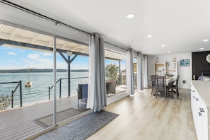 Your views from inside will not disappoint. 3 huge sliders lead out to the deck.