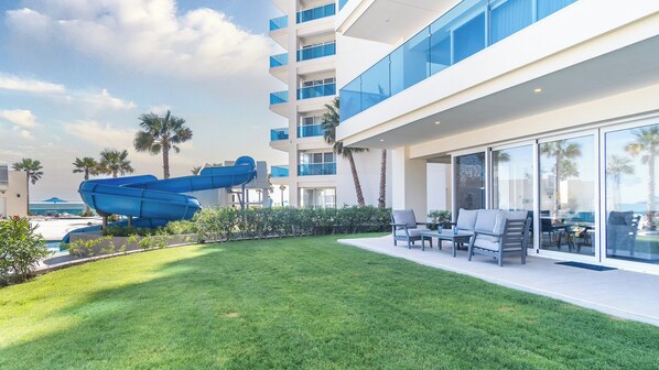 The grassy lawn rolls away from your patio.