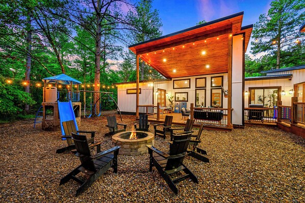 Amazing outdoor space with a playset, firepit area and hot tub