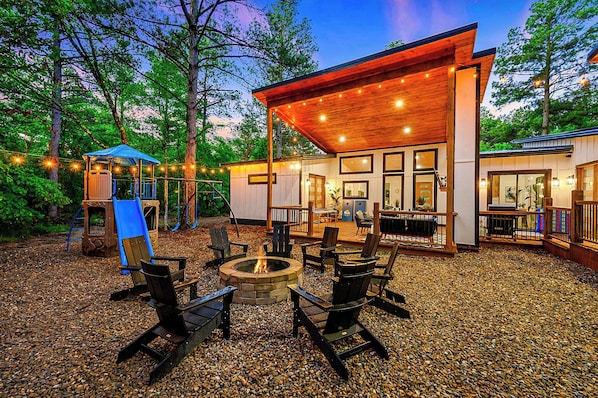 Amazing outdoor space with a playset, firepit area and hot tub