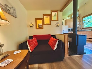 Full size sleeper located in cozy hang out nook.