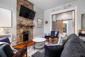 Living Room:  Enjoy the classic original fireplace, with comfy seating.