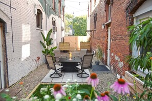 Our private patio, gas fire pit, string lights, pet grass pad potty.