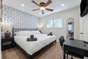 Cozy bedroom with king bed, workspace, and stylish decor