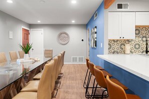Enjoy seamless dining with the kitchen just steps away—perfect for effortless meals and entertaining.