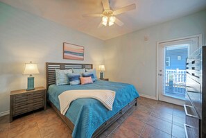 The primary bedroom features a king bed, access to the balcony, TV, and an ensuite bathroom. (Over Board)