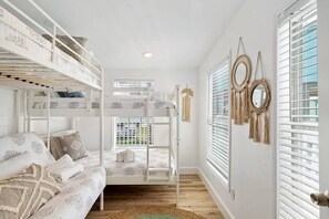This bedroom has a twin bunk bed and a twin-over-full bunk bed