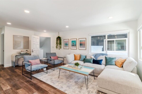 Sun soaked living room with designer furniture to relax and enjoy 