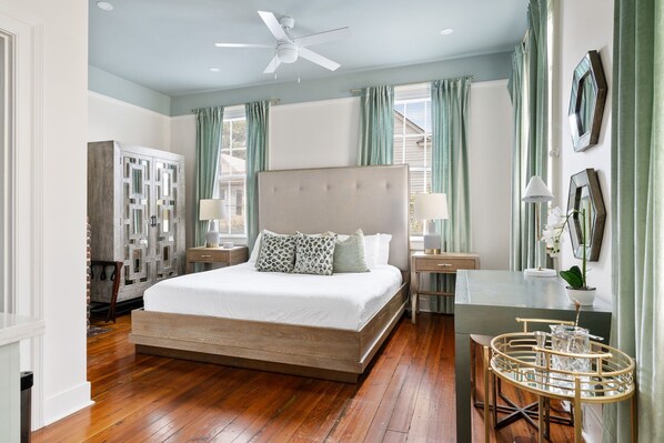 Sleep like royalty in this serene, sunlit bedroom, elegant drapery, and tasteful decor, your private sanctuary after a day of exploring.