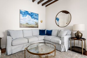 Chic corner sofa with modern art and soft lighting.