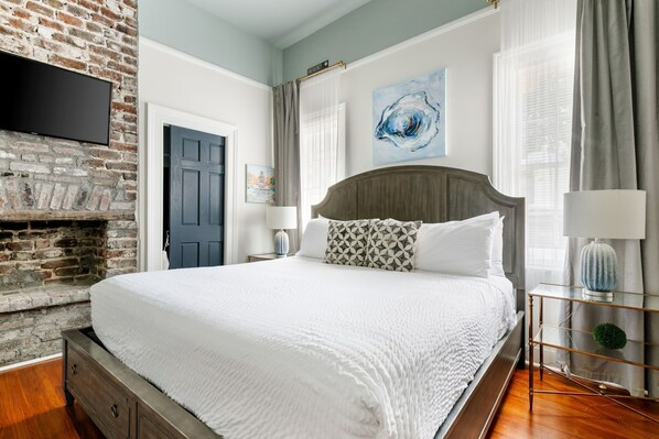 Inviting bedroom and exposed brick accents.
