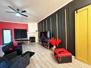 🔥 Indulge in a Luxurious & Private Kinky Escape 🔥
Step into an elegant, adults-only retreat designed for ultimate pleasure and relaxation. This stylish living space features modern decor, LED mood lighting, and a cozy fireplace to set the perfect ambiance. Enjoy a 75” Smart TV, plush seating, and exclusive amenities like a spanking bench, queening chair, and massage table fo...