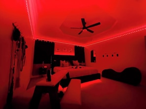 🔥 Step Into Your Ultimate Fantasy Escape 🔥
Indulge in a sensual, intimate, and luxurious getaway at this one-of-a-kind adult retreat. The moody red LED lighting sets the perfect ambiance for unforgettable nights. Featuring a king-size bed, spanking bench, queening chair, and a full wall of premium floggers & restraints, this space is designed for exploration and pleasure.
✨...