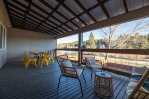 A beautiful outdoor deck with stylish tables and chairs, perfect for relaxing and entertaining.