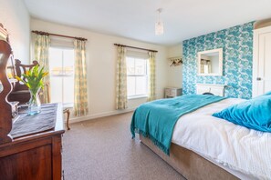 Harriet's, Cromer: Master bedroom with double windows and a glimpse of the sea