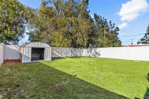 Large fenced lawn for pets, yard games, and soaking up Florida sunshine