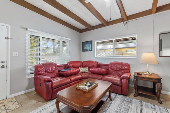 Large living room with plush comfy leather sofas perfect for family movie nights
