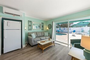Step right out to poolside relaxation from this comfy living space.