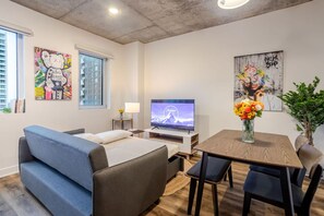 Contemporary living area with TV and dining space