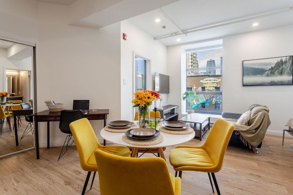 Bright and modern space with stylish dining, bold accents, and sweeping city views