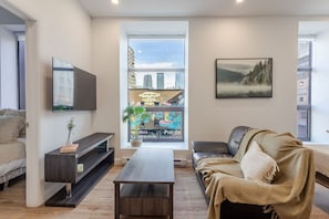 Cozy lounge with a Smart TV and window views—ideal for movie nights
