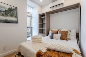 Queen Murphy bed setup with layered pillows and soft textures for restful sleep