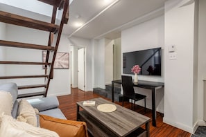 Comfortable seating and warm tones frame this bright, loft-style living space