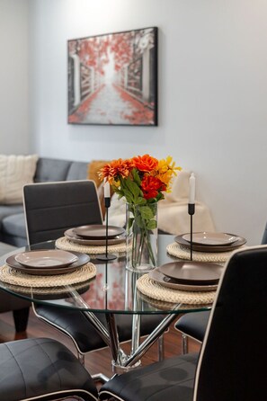 Chic and intimate dining setup, styled with soft lighting and cheerful floral touches