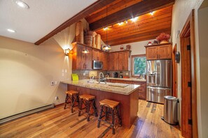 Full kitchen with bar island seating. 