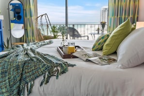 Breakfast in the plush king bed, overlooking the beach!